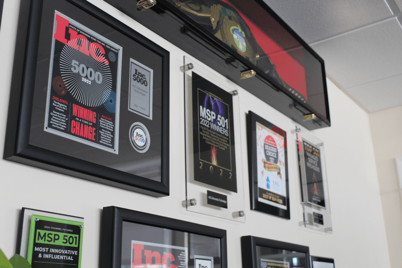 ASG's award wall, framed Inc. 5000, Channel Futures MSP 501, and Readers' Choice honors hanging in the Wallingford office