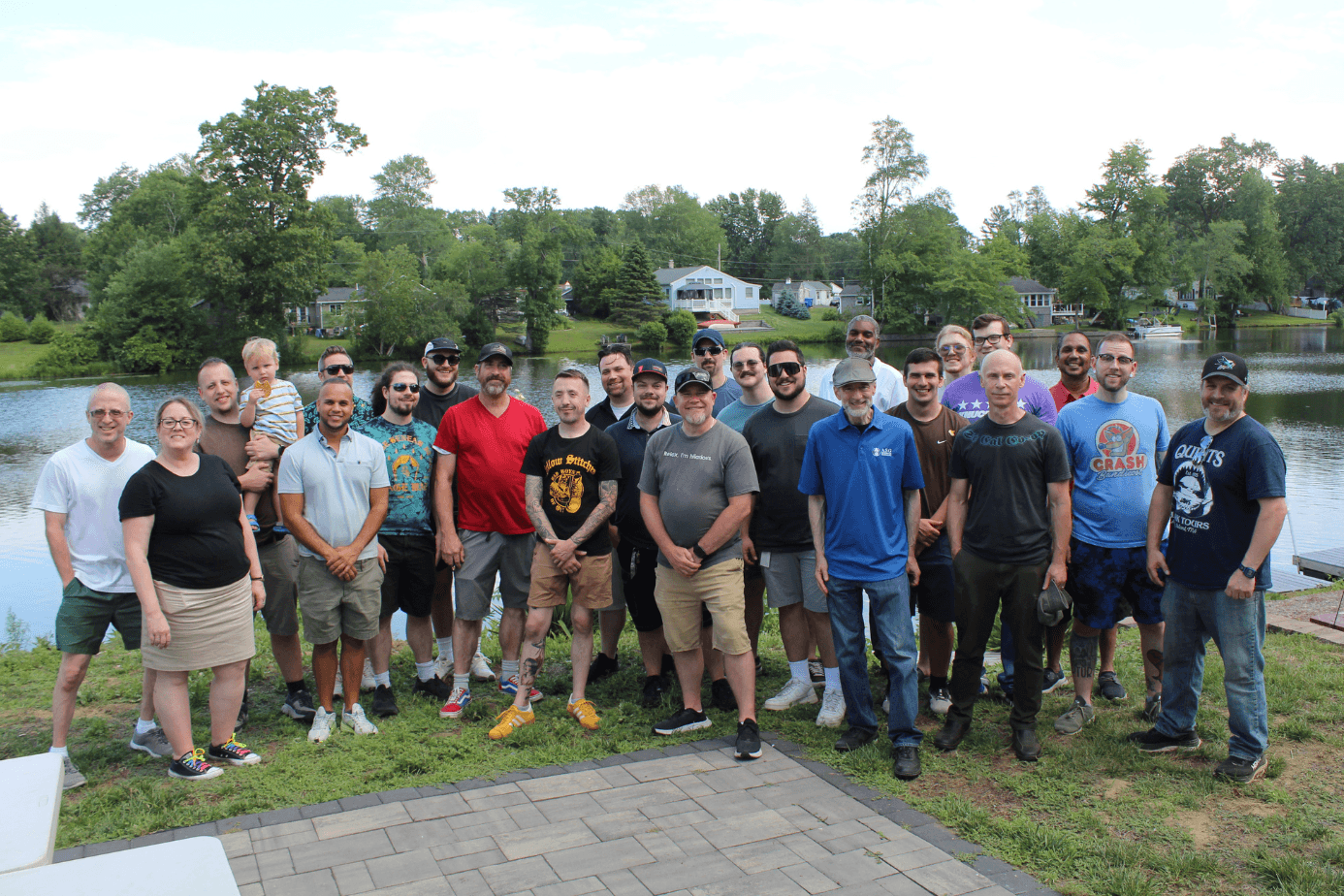 The ASG Information Technologies team at the 2025 company party by the lake