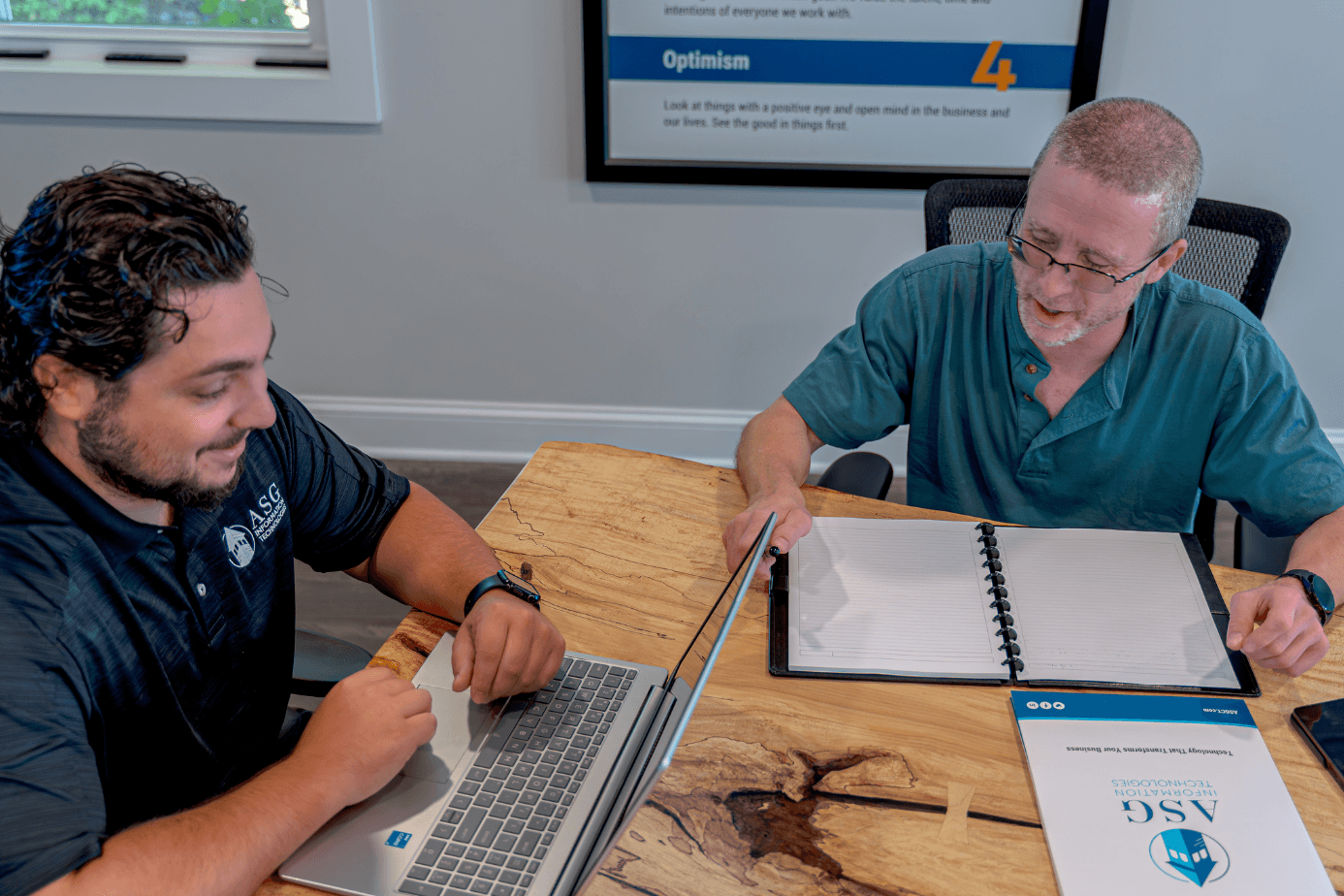 An ASG Information Technologies team member reviewing technology plans with a client at the Wallingford, Connecticut office