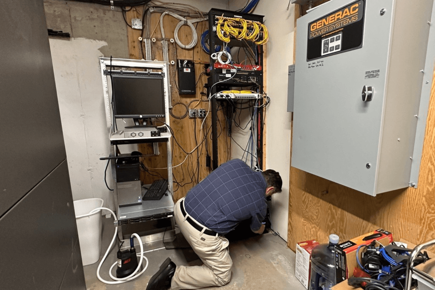 An ASG technician installing and cabling a server rack at a client site